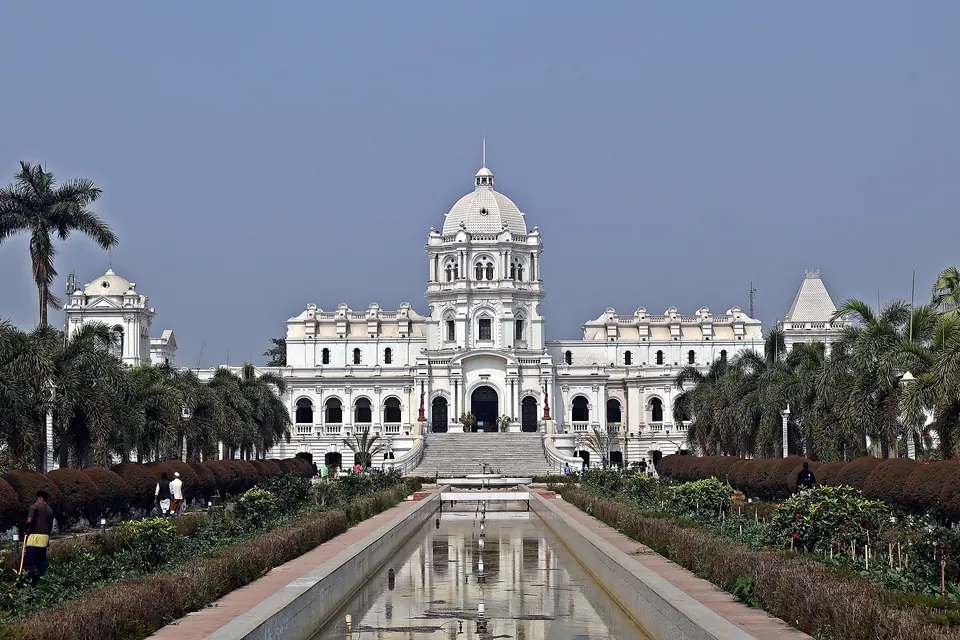 The white domes and towers of Ujjayanta Palace in Agartala behind a long reflecting pool and gardens