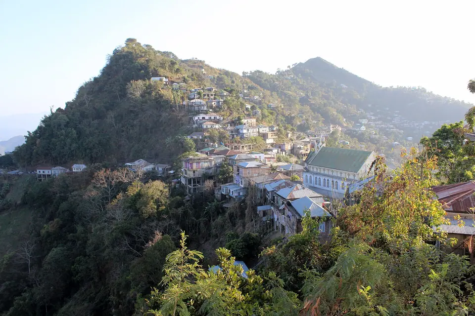 Houses of Melthum veng clinging to a green hilltop in Aizawl