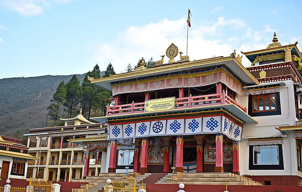 The Gontse Gaden Rabgye Ling monastery at Bomdila with red pillars and gold roofs under a blue sky