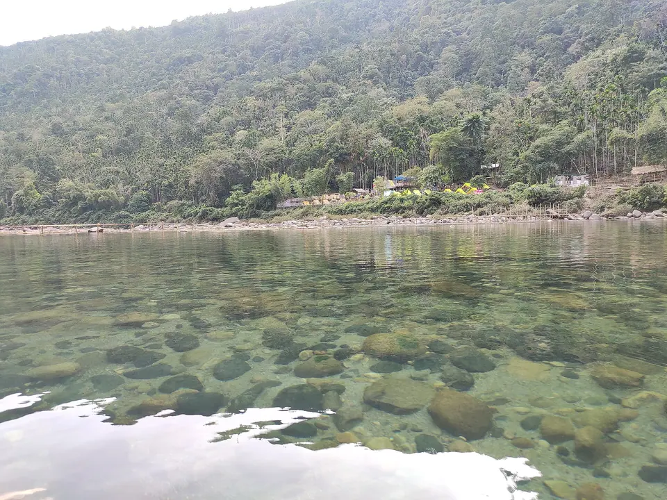 River stones visible through the clear, shallow water of the Umngot River at Dawki