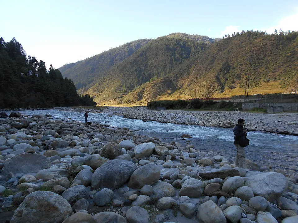 A wide boulder-strewn stretch of the Dirang river in morning light, Arunachal Pradesh