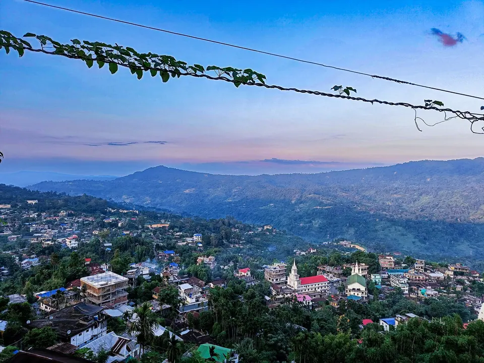 Haflong town spread over green hills in the soft light of dusk, seen from Synod viewpoint