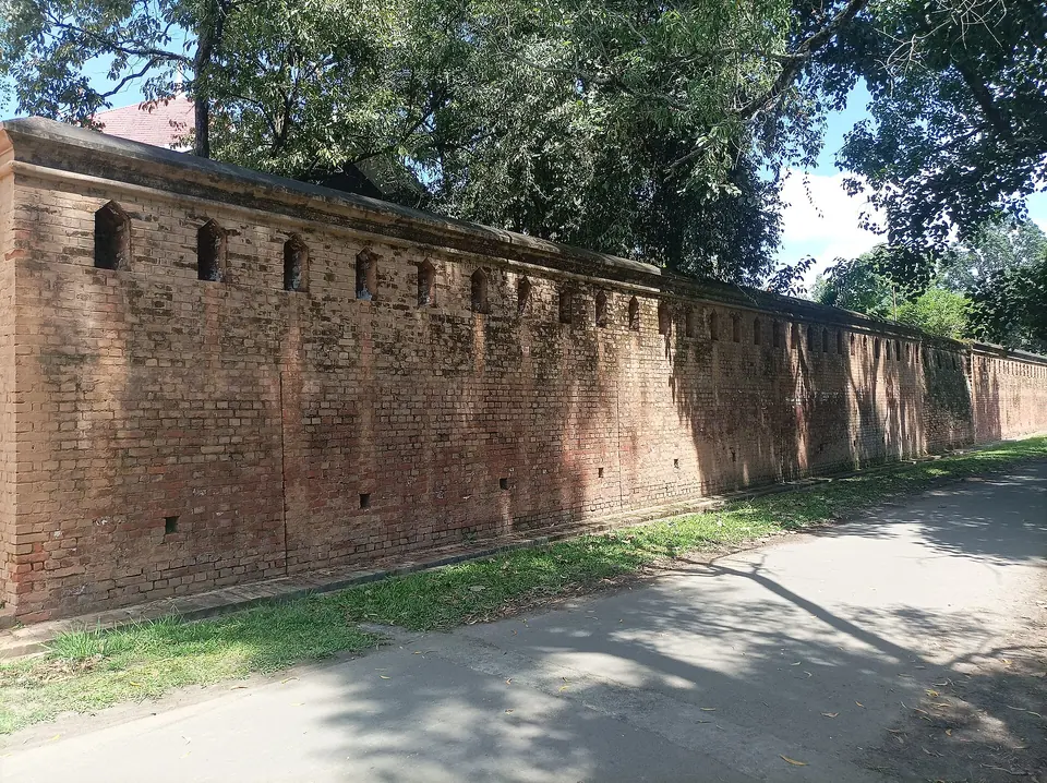 The long red-brick wall of the Kangla Uttra Shanglen enclosure inside Kangla Fort, Imphal