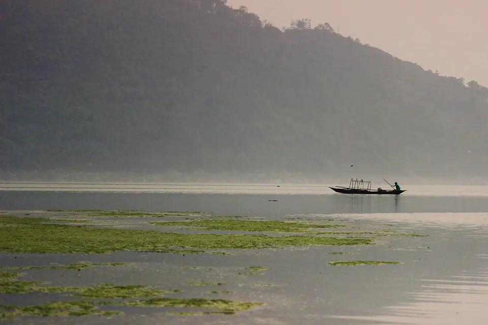 A lone fishing boat on the misty Brahmaputra near IIT Guwahati at dawn