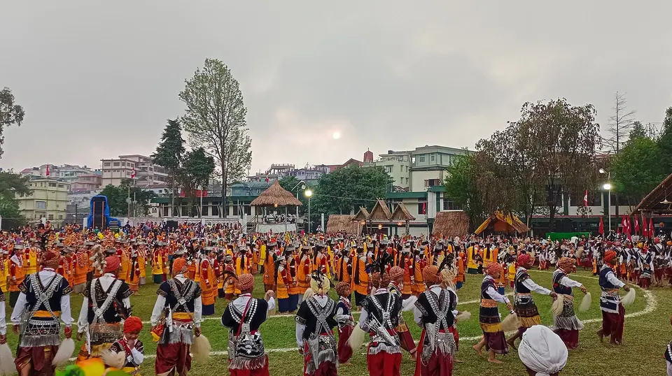 Rows of Khasi dancers in traditional dress circling the ground at Shad Suk Mynsiem festival, Shillong