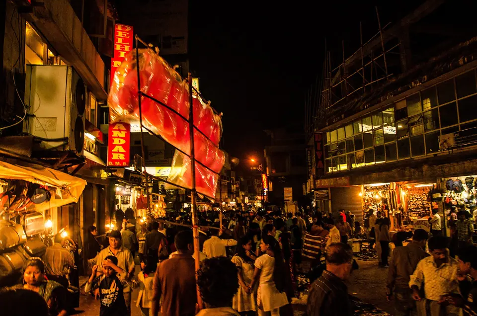 Evening crowds and lit shopfronts along a busy street in Police Bazaar, central Shillong