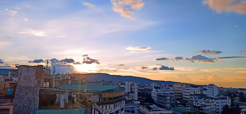 Sunset clouds over the rooftops and hills of Shillong city